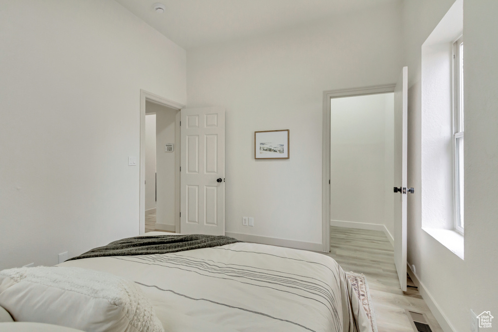 Bedroom with light wood-style flooring and baseboards