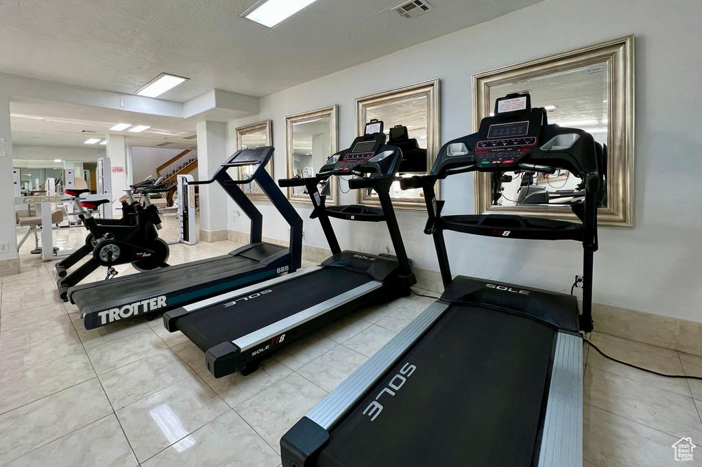 Exercise room featuring tile patterned floors