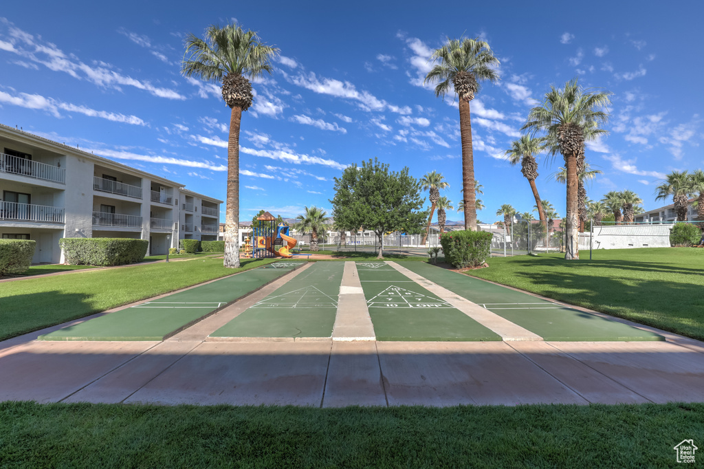 View of home's community with a yard and shuffleboard