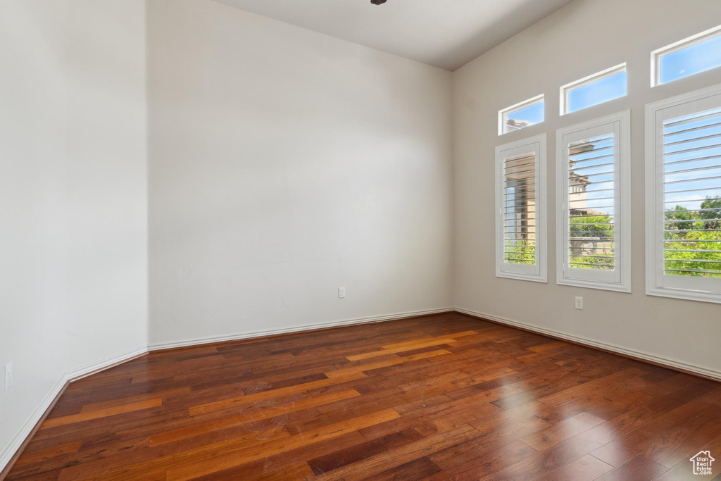 Unfurnished room with hardwood / wood-style flooring and baseboards