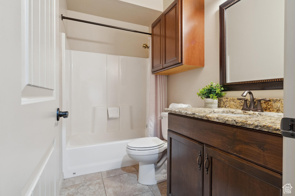 Full bathroom featuring vanity, toilet, shower / tub combination, and tile patterned floors