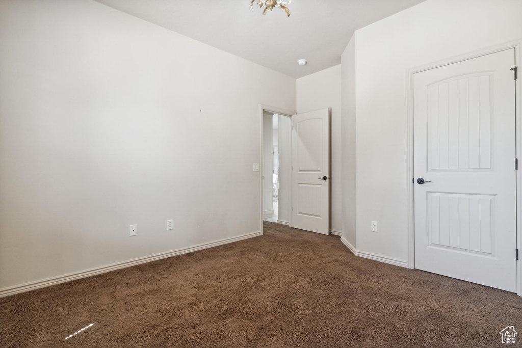 Unfurnished bedroom featuring carpet floors and baseboards
