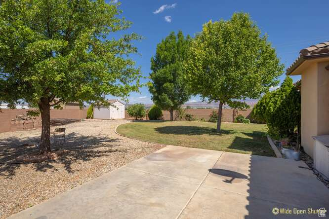 View of yard featuring a storage shed, a patio, and an outdoor structure
