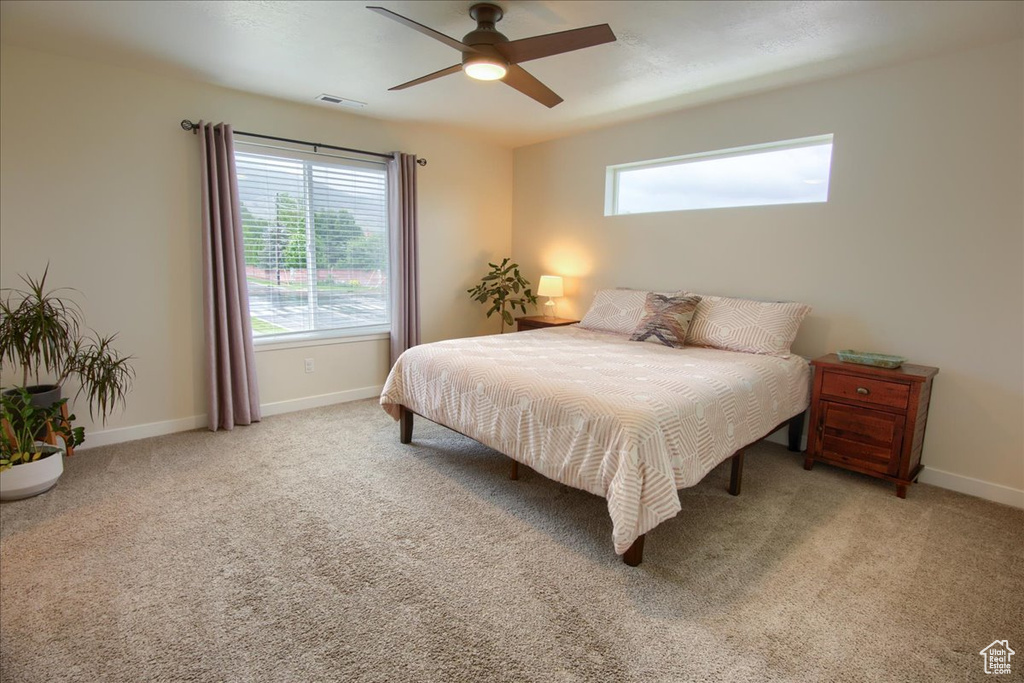 Bedroom featuring baseboards, carpet, and ceiling fan
