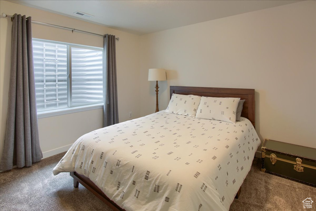Bedroom with carpet floors and baseboards