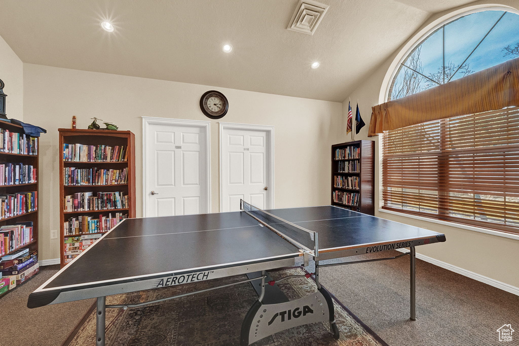 Recreation room featuring carpet floors, vaulted ceiling, baseboards, and recessed lighting