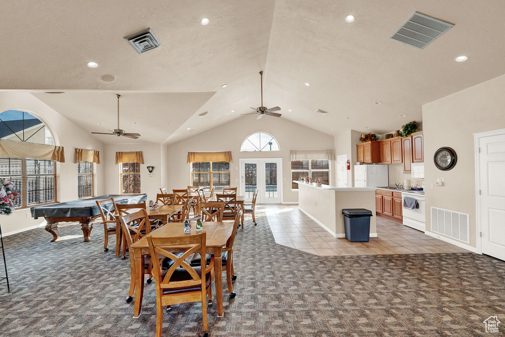 Dining space with light colored carpet, a ceiling fan, lofted ceiling, recessed lighting, and baseboards