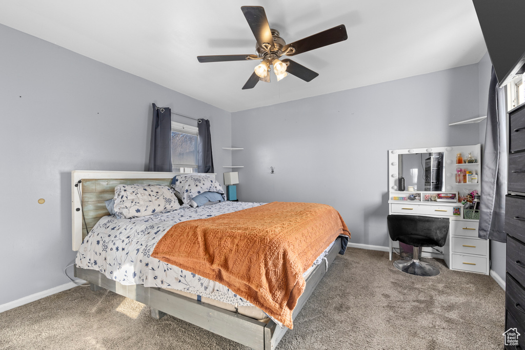 Bedroom with baseboards, carpet floors, a ceiling fan, and a desk