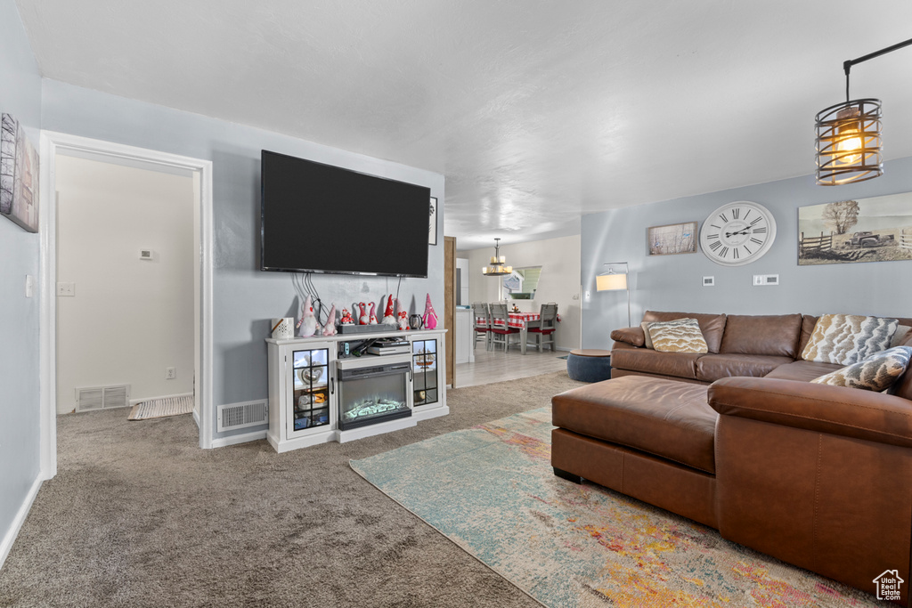 Living area featuring carpet flooring and baseboards