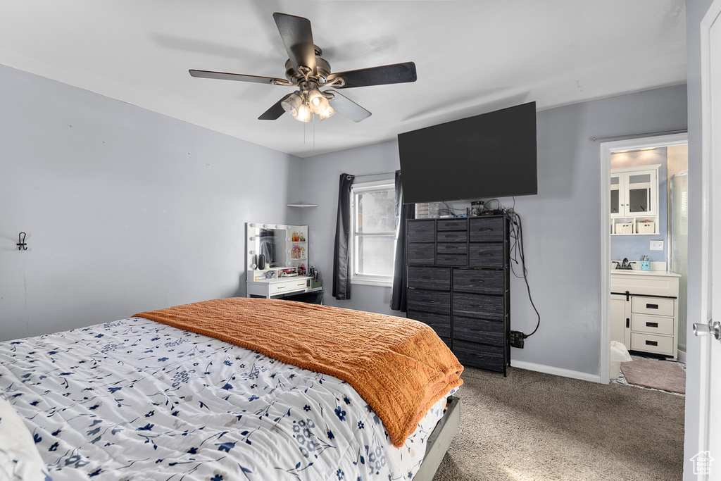 Bedroom featuring carpet floors, ceiling fan, baseboards, and a sink