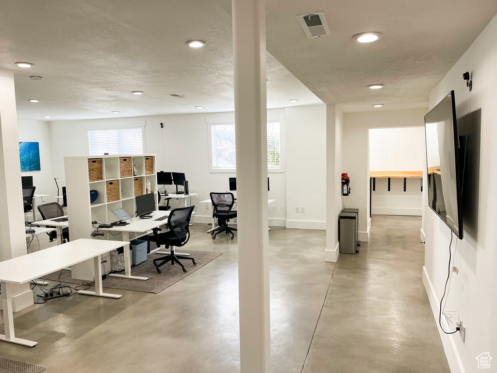 Office featuring concrete floors, recessed lighting, and baseboards