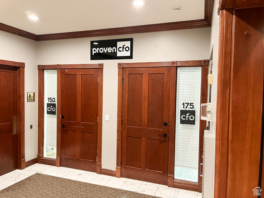 Foyer featuring ornamental molding, baseboards, and recessed lighting