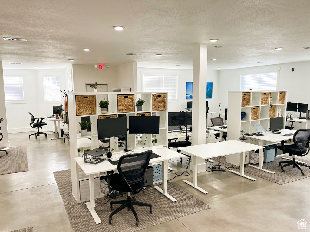 Office with plenty of natural light, recessed lighting, and finished concrete floors