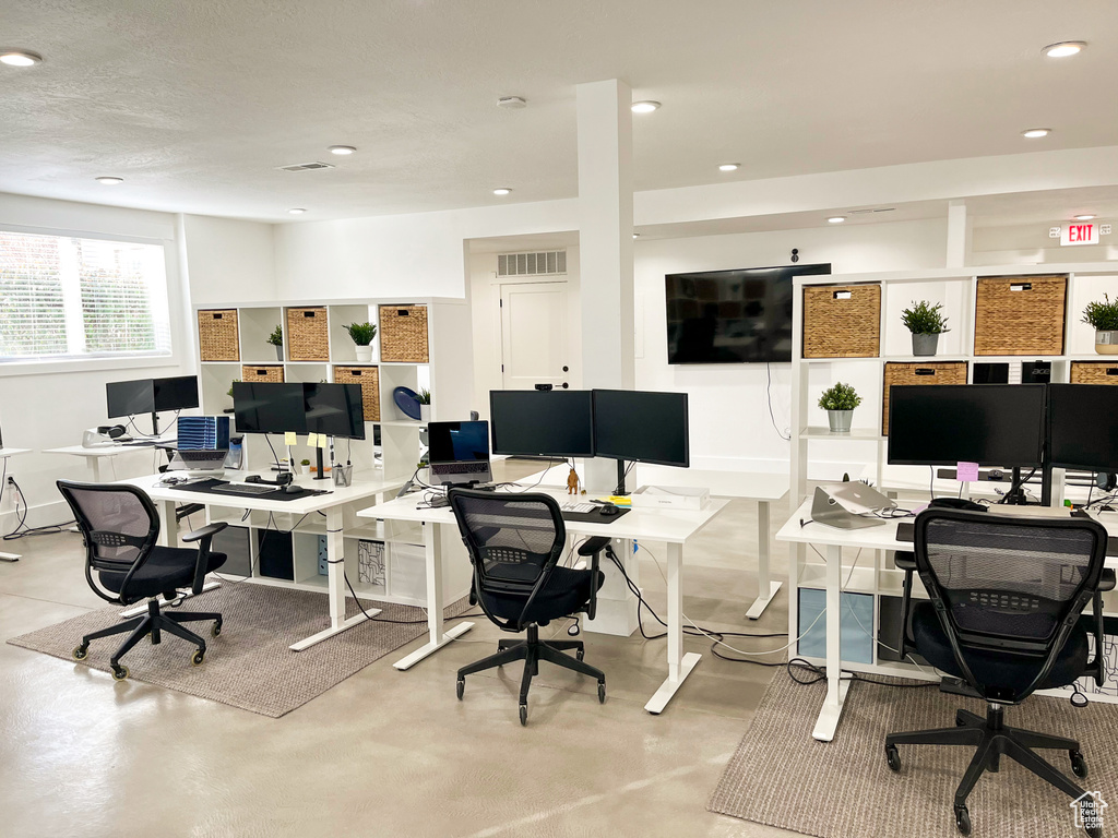 Office area with concrete flooring and recessed lighting