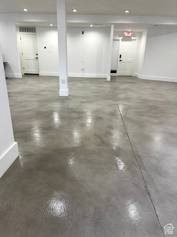 Garage featuring baseboards and recessed lighting
