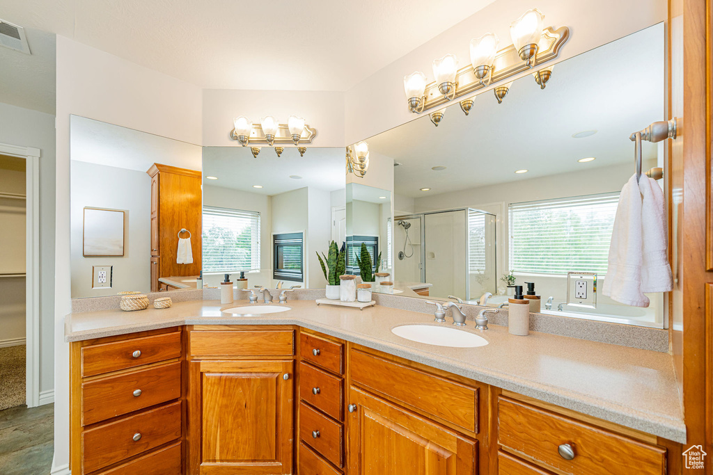 Full bathroom with a shower stall and double vanity
