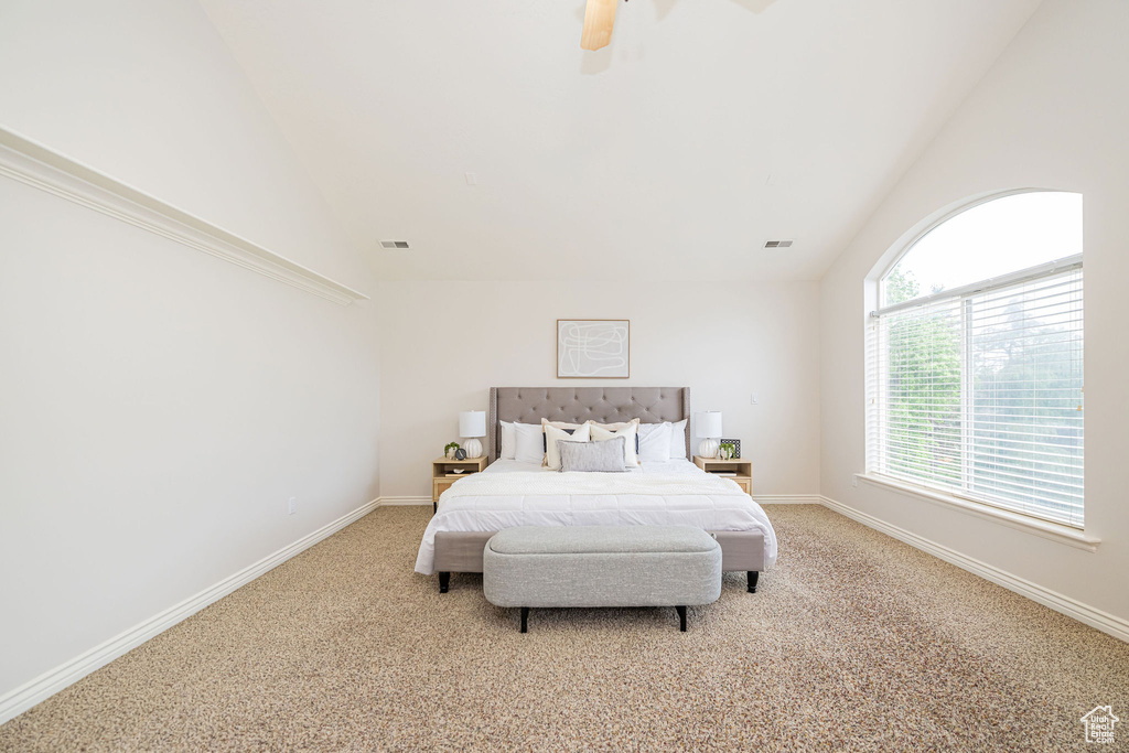 Bedroom featuring light colored carpet, ceiling fan, high vaulted ceiling, and baseboards