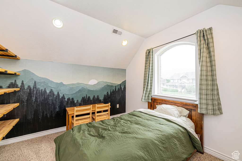 Carpeted bedroom with lofted ceiling, a mountain view, and baseboards