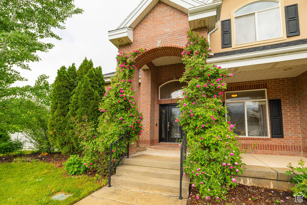 Property entrance featuring brick siding