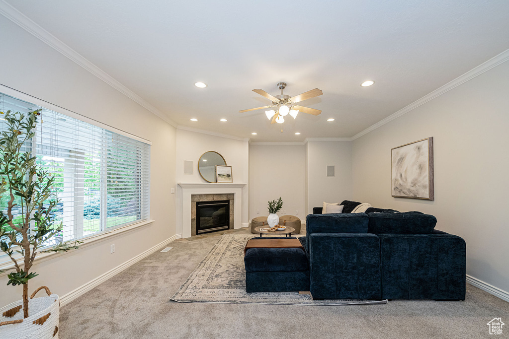 Living room featuring light colored carpet, recessed lighting, a ceiling fan, a tile fireplace, and baseboards