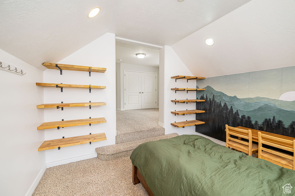 Bedroom featuring lofted ceiling, carpet flooring, baseboards, and recessed lighting