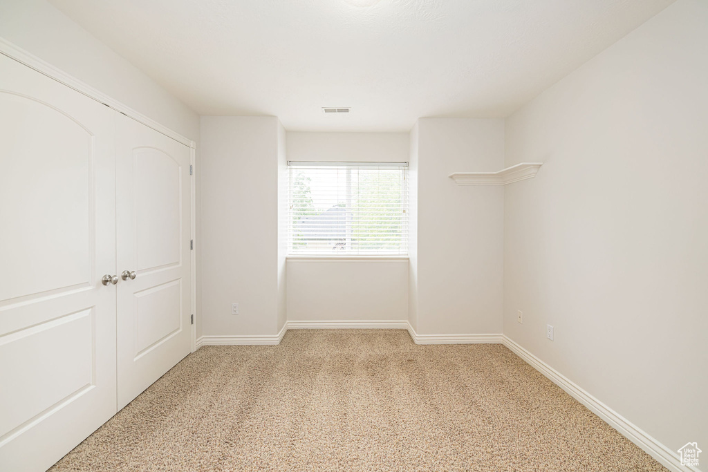 Unfurnished bedroom featuring carpet flooring and baseboards