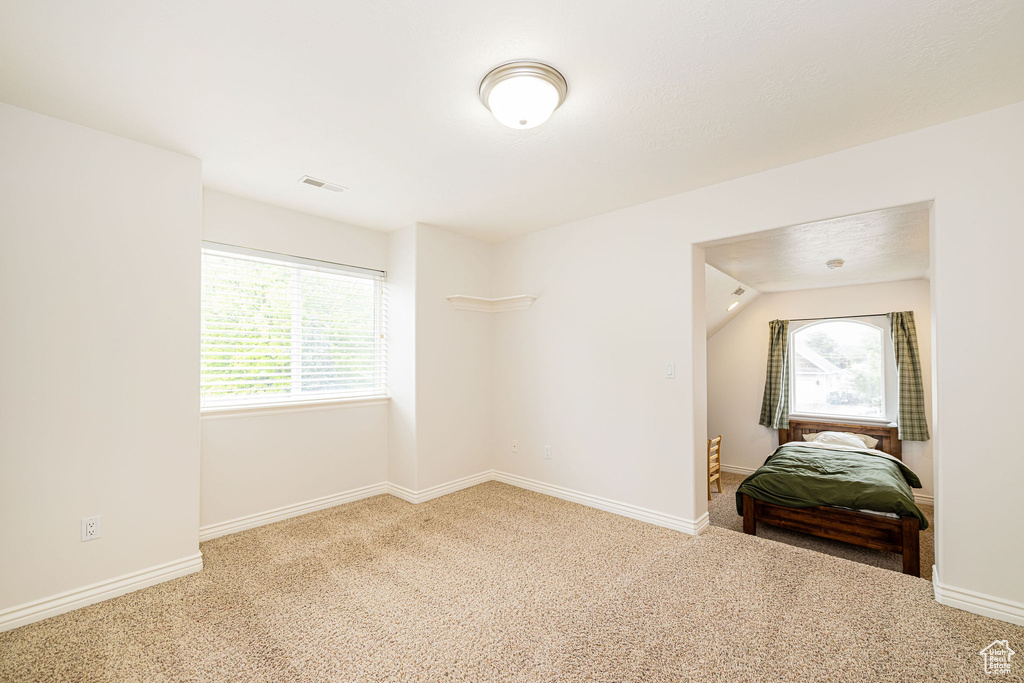 Bedroom with carpet floors and baseboards