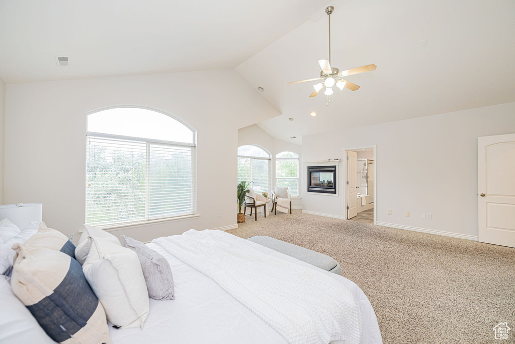 Bedroom featuring lofted ceiling, baseboards, light carpet, and a ceiling fan