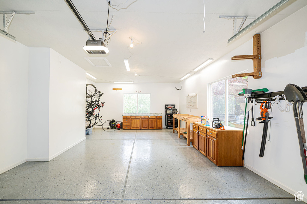 Garage with a garage door opener and baseboards