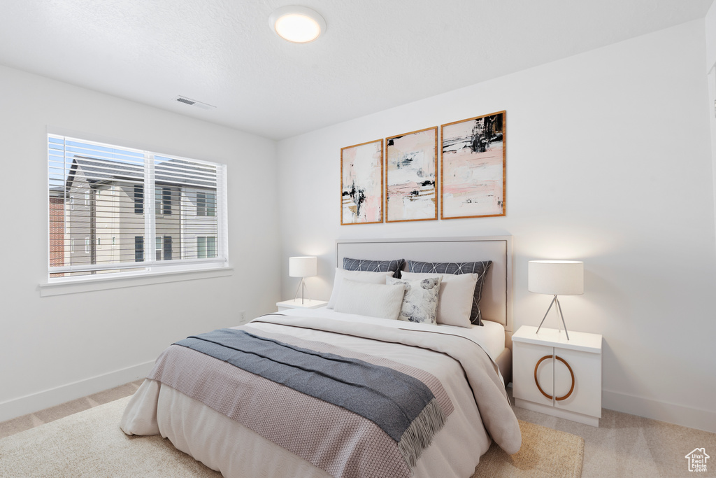 Carpeted bedroom with baseboards