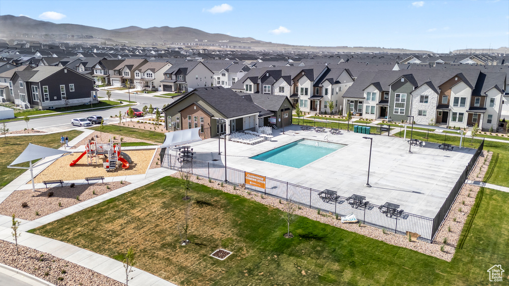 Community pool featuring a residential view, fence, a mountain view, and a patio