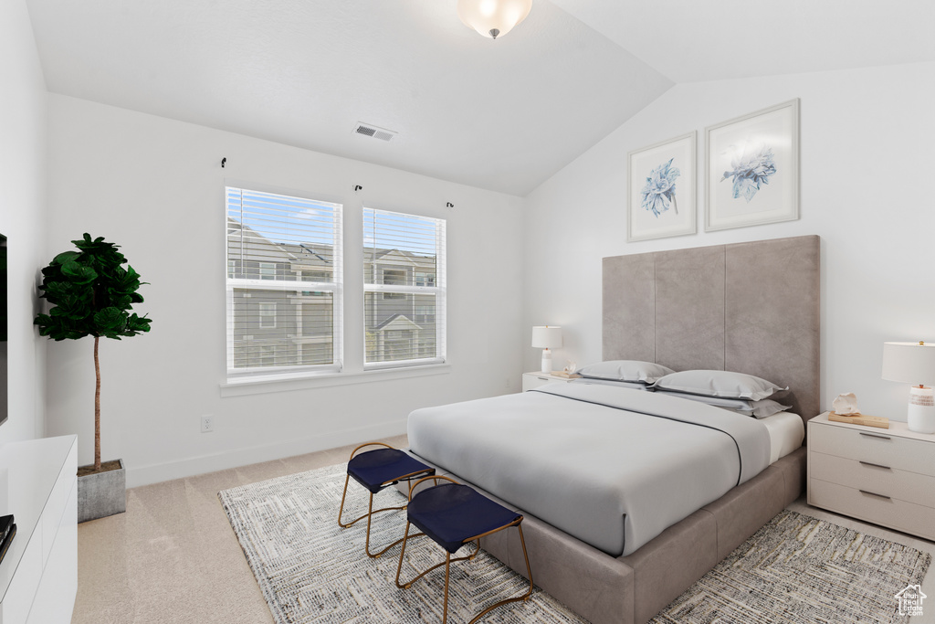 Carpeted bedroom with lofted ceiling