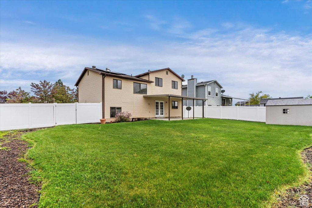 Back of property featuring french doors and a patio