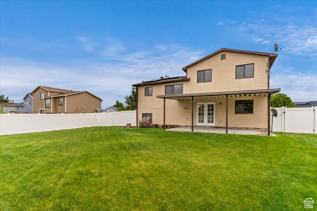 Rear view of house featuring a patio area and french doors