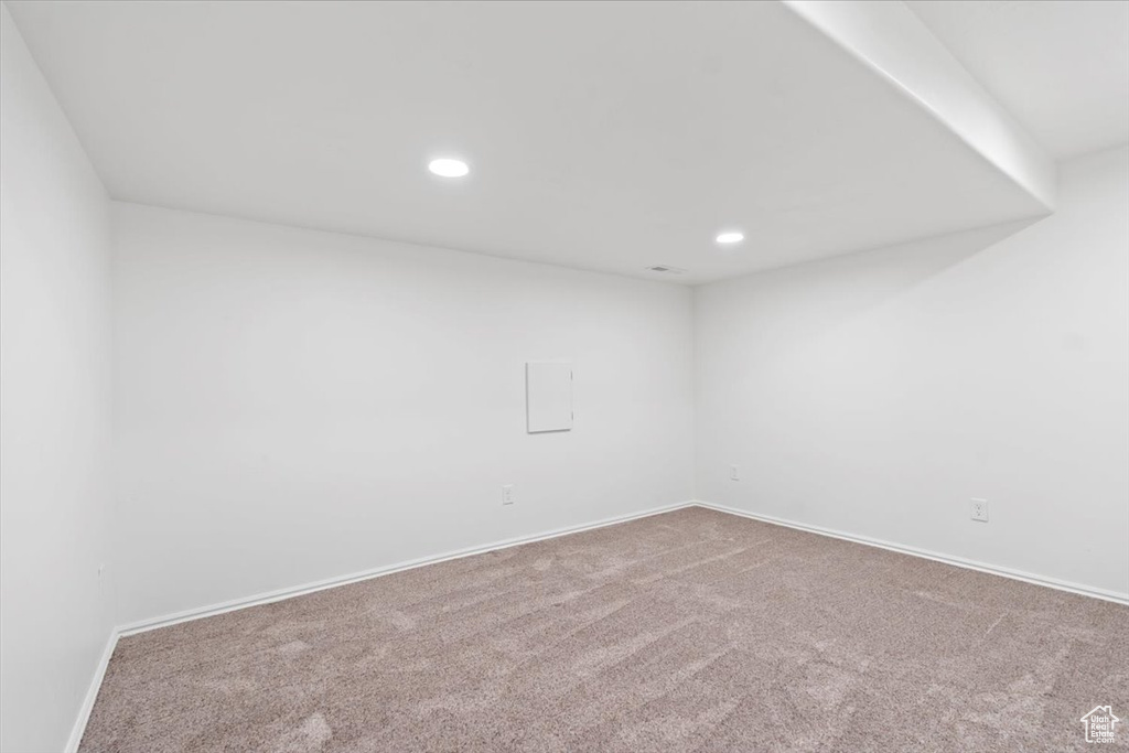 Carpeted spare room featuring baseboards and recessed lighting