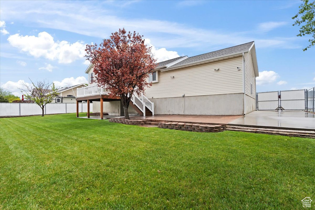 Rear view of property with stairs, a deck, and a patio
