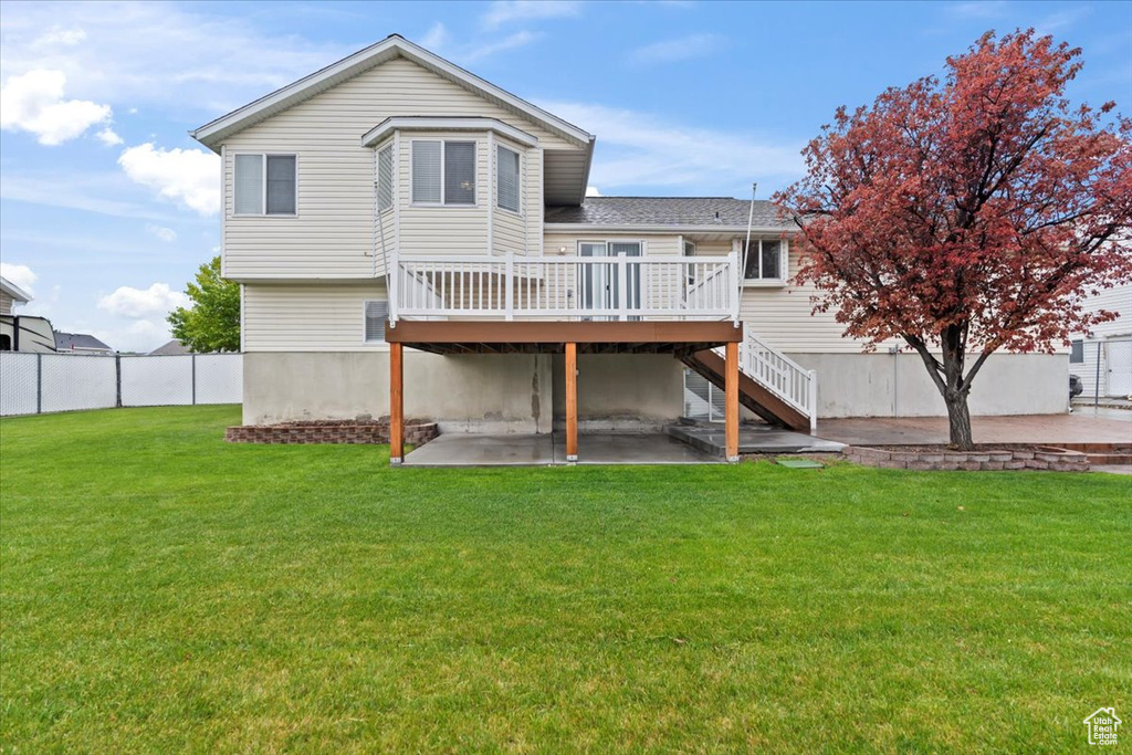 Back of house with a patio area, a deck, and stairs