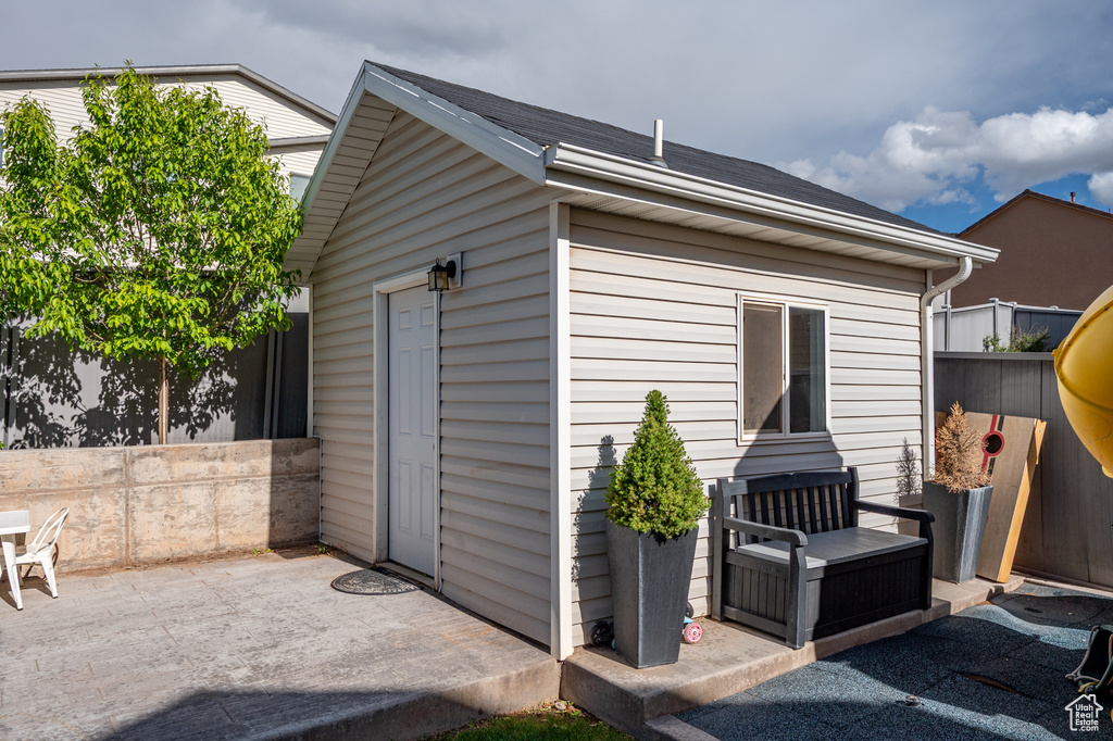 View of outbuilding with fence and an outdoor structure