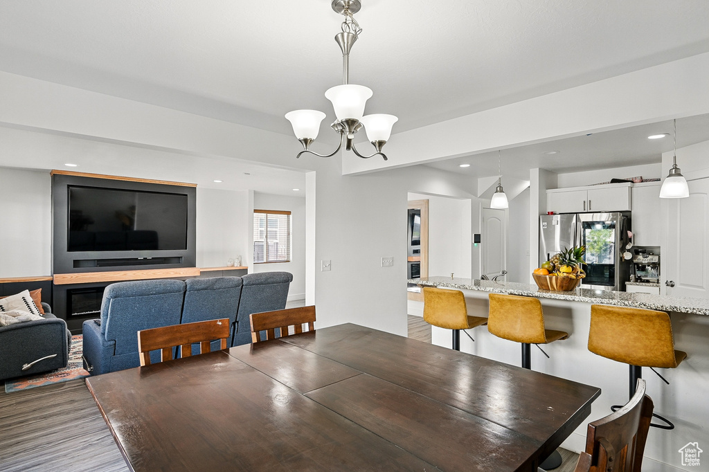 Dining area with a chandelier, recessed lighting, and wood finished floors