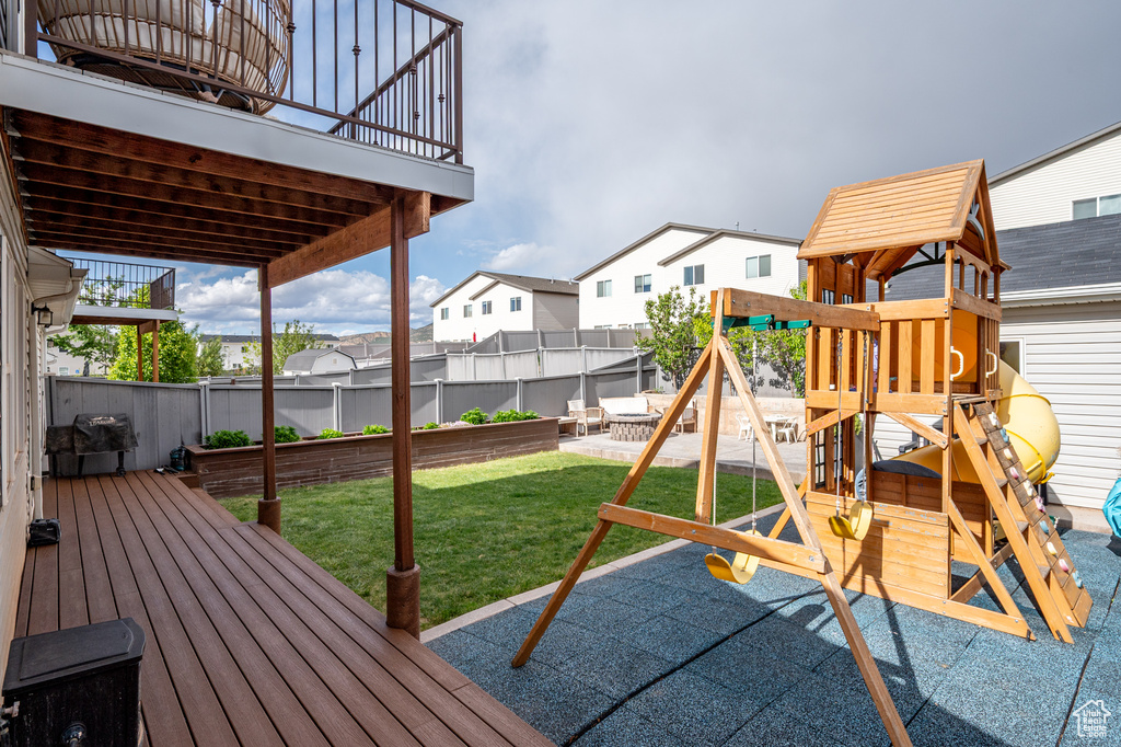 View of jungle gym featuring a residential view and a deck