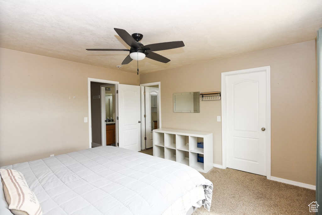 Bedroom featuring carpet flooring, baseboards, and ceiling fan