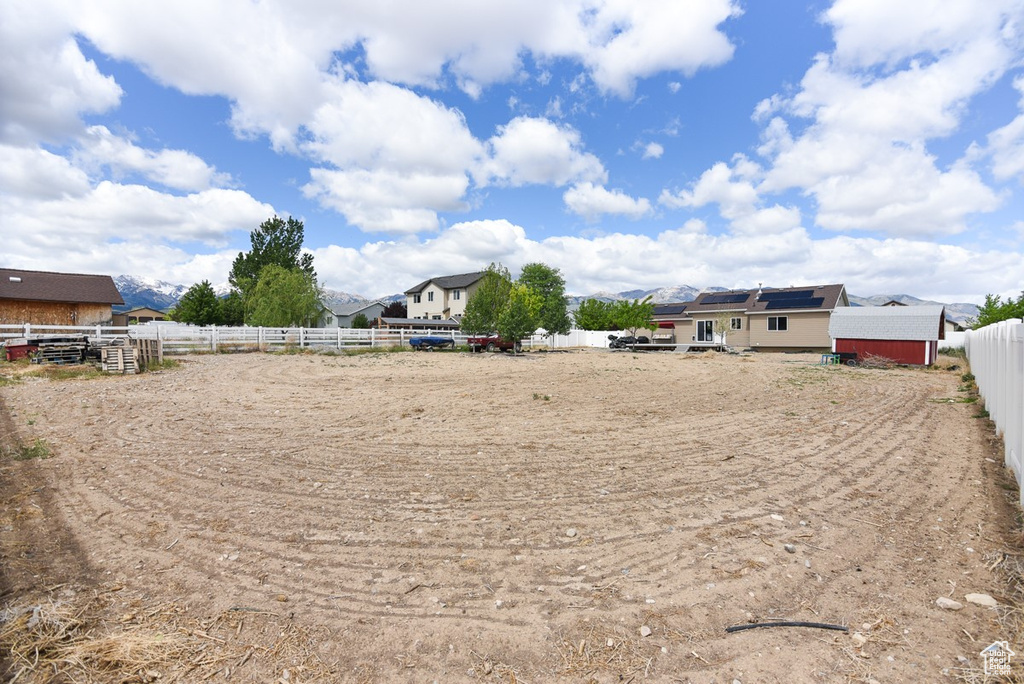 View of yard featuring fence and an enclosed horse arena