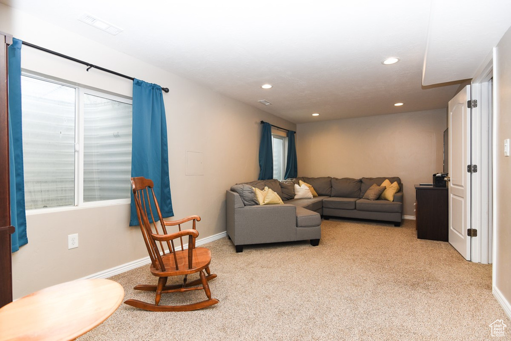 Living room featuring light carpet, recessed lighting, and baseboards
