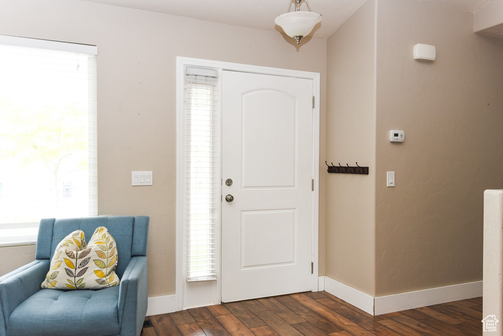 Foyer entrance featuring dark wood-style floors and baseboards