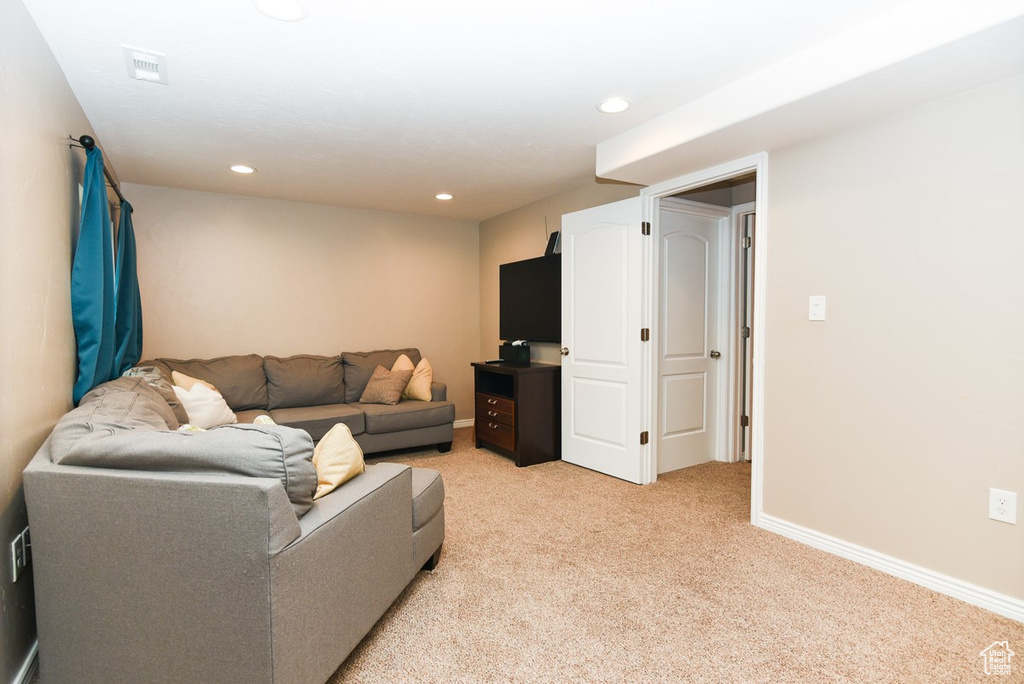 Living room featuring light colored carpet, recessed lighting, and baseboards