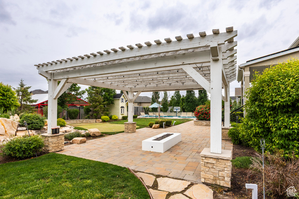 View of patio / terrace with a pergola and an outdoor fire pit