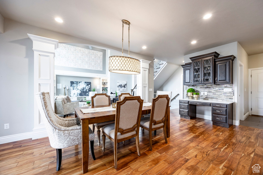 Dining room featuring wood finished floors, recessed lighting, stairway, and baseboards