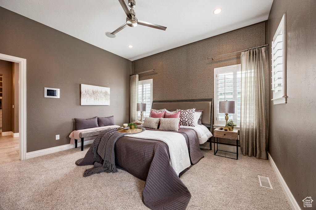 Bedroom featuring light carpet, a ceiling fan, baseboards, and recessed lighting