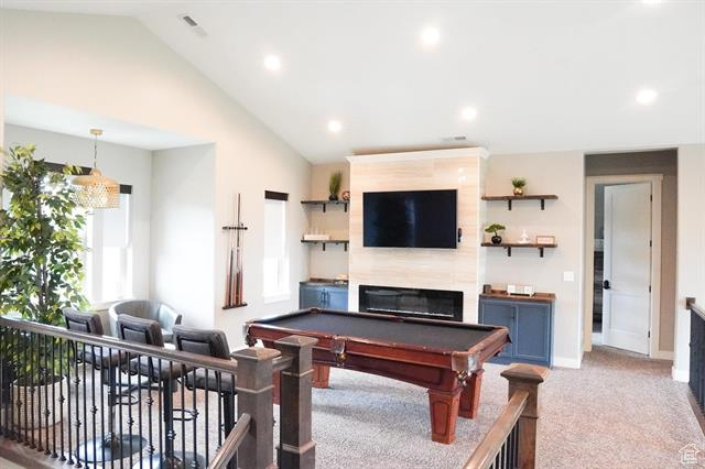 Recreation room with lofted ceiling, light carpet, pool table, baseboards, and recessed lighting