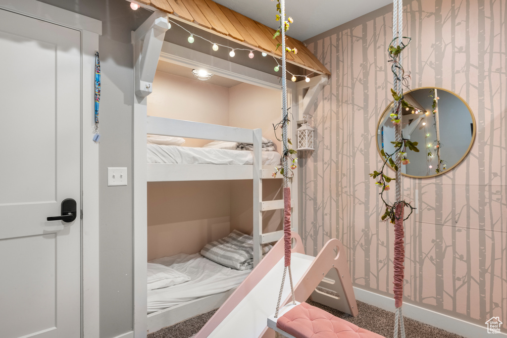 Carpeted bedroom with wallpapered walls